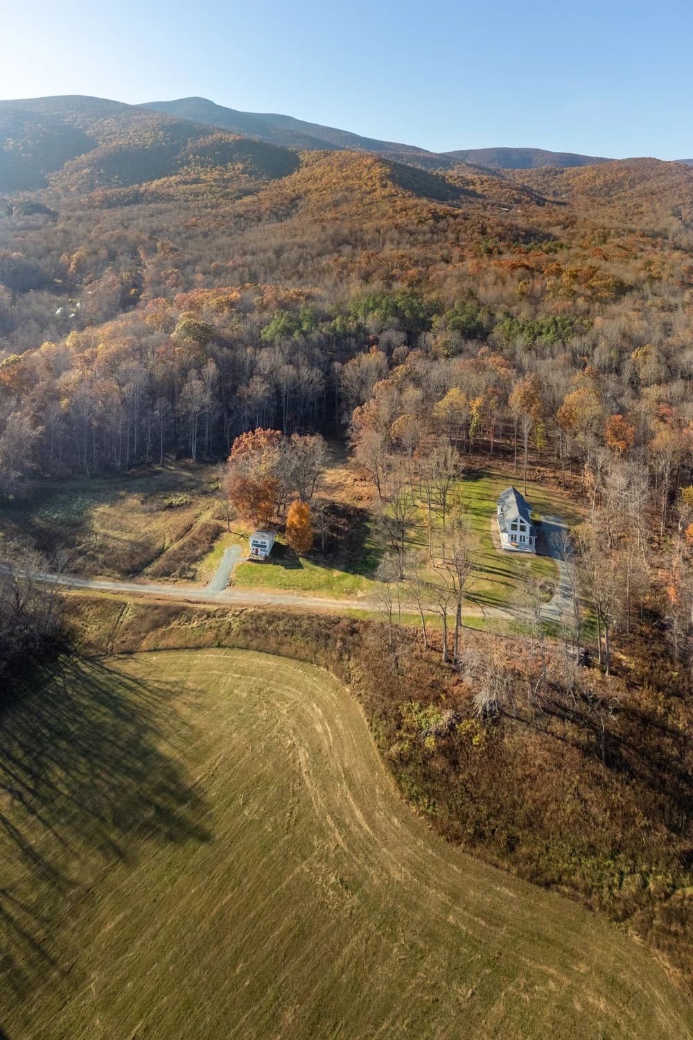 Aerial view of the meadow and both homes with the Blue Ridge beyond