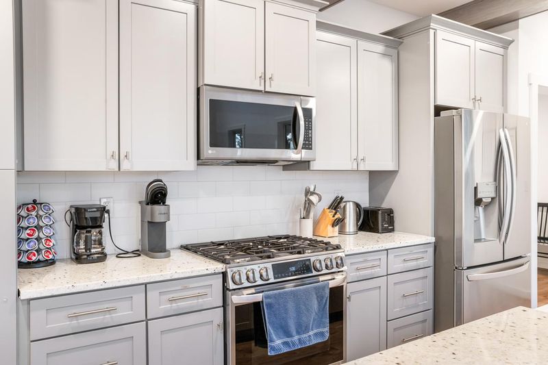 The gas range, coffee station and kitchen storage