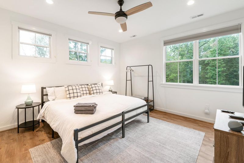 An upstairs bedroom, bright with windows on two walls