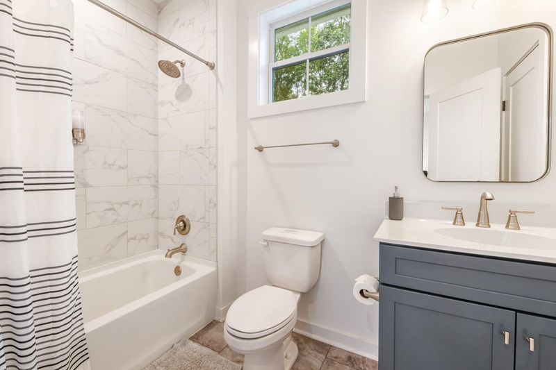 The upstairs bathroom, with a tub and shower